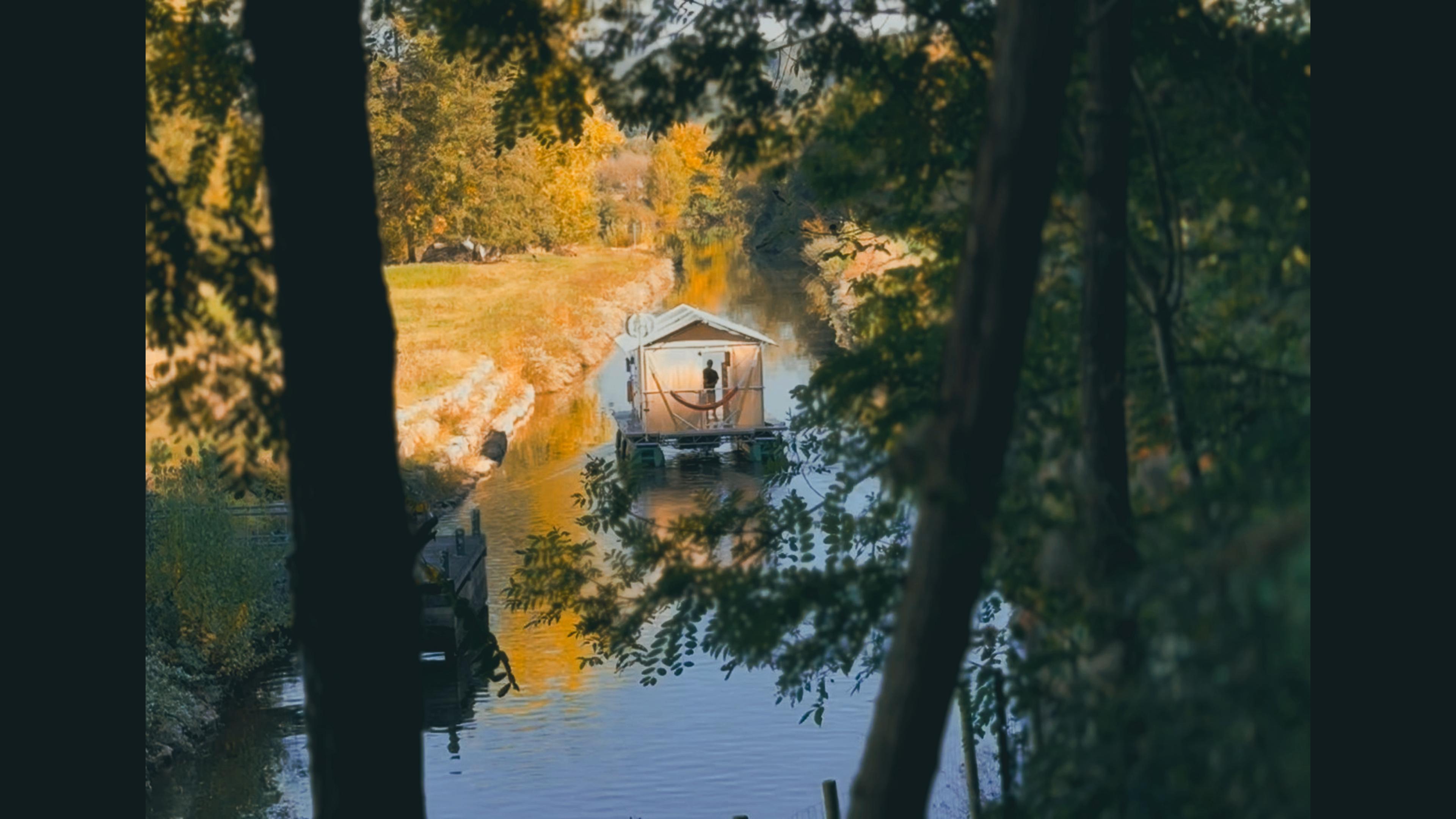 The Glamping Boat moored on the bank in autumn